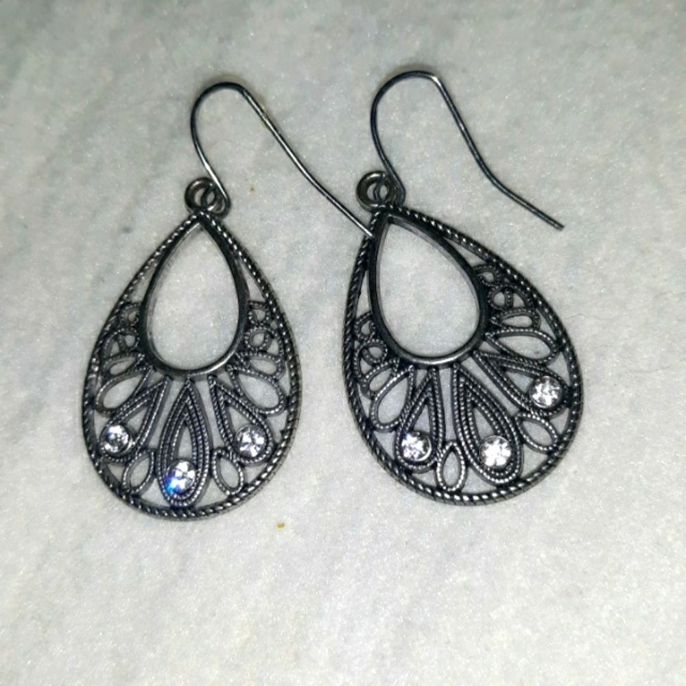 Chrome with Rhinestones in the middle of each Earring. Brand new.